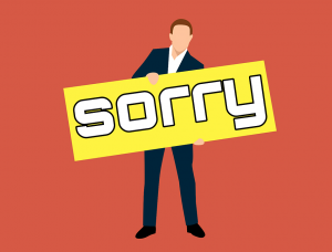 Man holding sorry sign