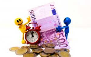 figurines holding clock and euro bill