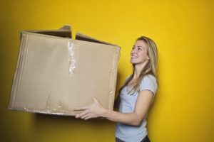Woman holding a big box.
