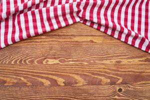 A red and white rag on the wooden floor