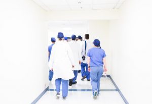 A group of doctors walking down a hallway.
