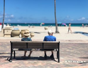 Senior couple on a beach bench.