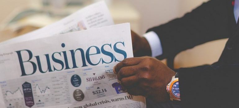 A person holding business papers. 
