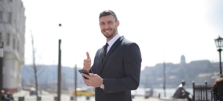 A smiling businessman holding thumbs up for Largo FL commercial movers.