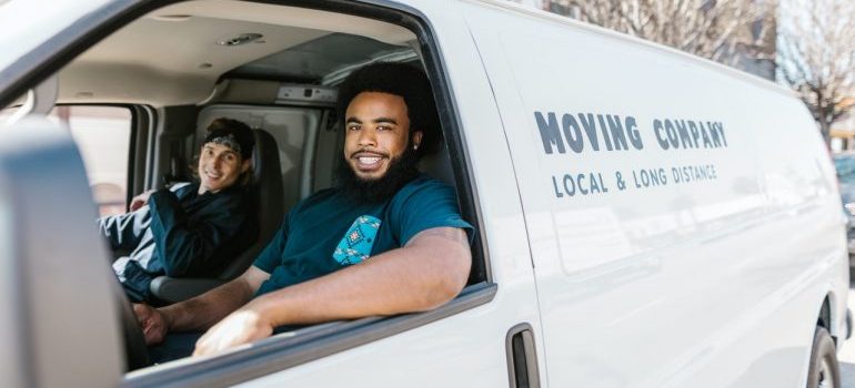 Two professional movers in a van