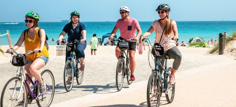 people driving bikes on a beach