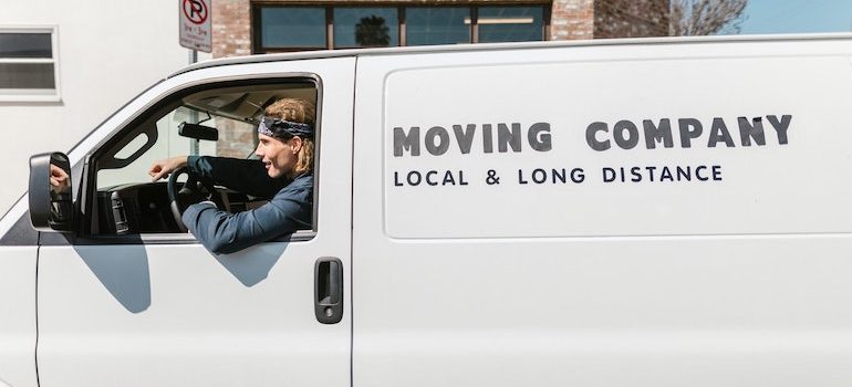 a moving van and a man driving it