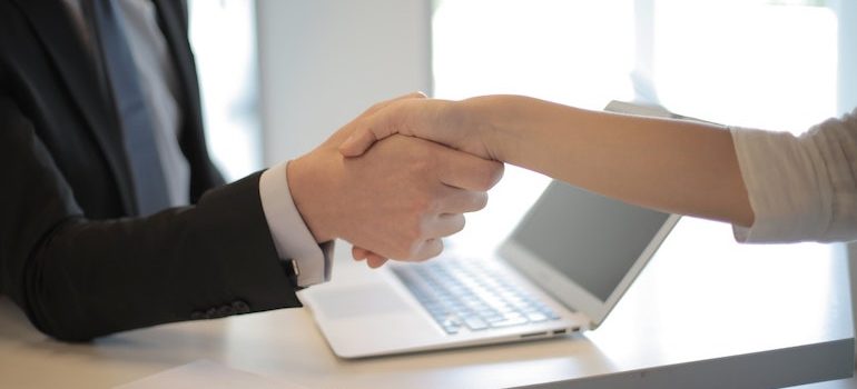 handshake with a computer in background
