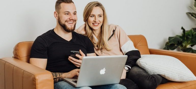 couple looking for moving companies Spring Hill on a laptop