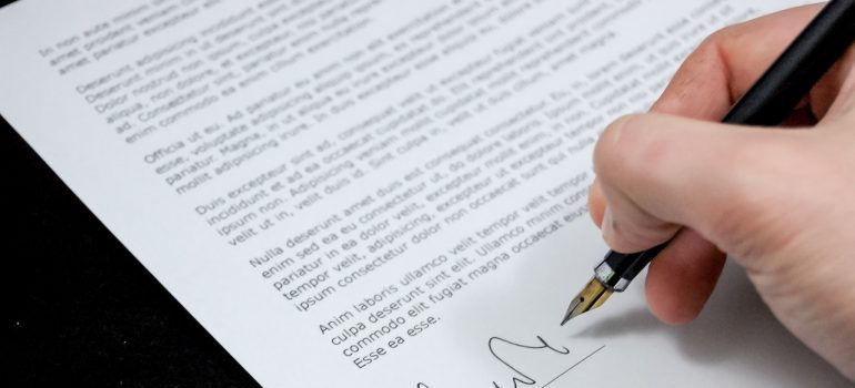 A man signing a document.