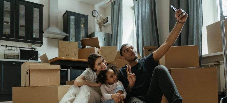 A young family taking a selfie during packing for a move