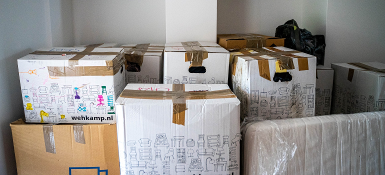 a stack of a large number of cardboard boxes in a room