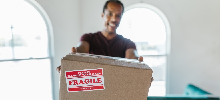 a man showing sealed moving box