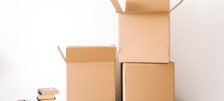 Three boxes in front of a white wall you might find while looking to buy moving boxes online
