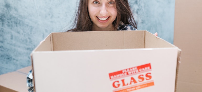 woman holding a moving box