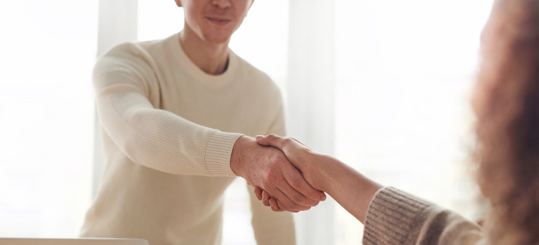 Man shaking hands after hiring movers to help him with moving from Miami to Coral Springs