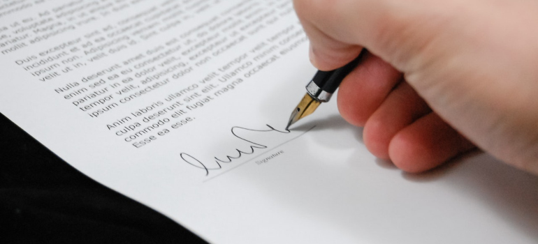 A person signing a contract.